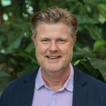 John de Beijer smiling in a greenhouse.