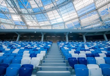 Empty chairs inside football stadium in blue and white.