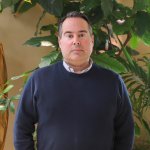 Roel Kruijtzer, HR employee at Planon, standing in a green house.