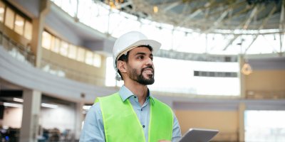 Engineer working on tablet by building inspection