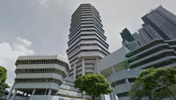 Planon Singapore highrise office concrete with trees.