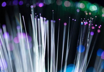 Optical fibers with rainbow colors pointing up.