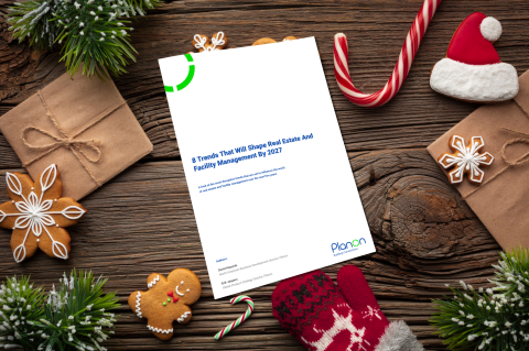 Cover of the "8 Trends that will shape real estate and facility management by 2027" and Christmas decoration.