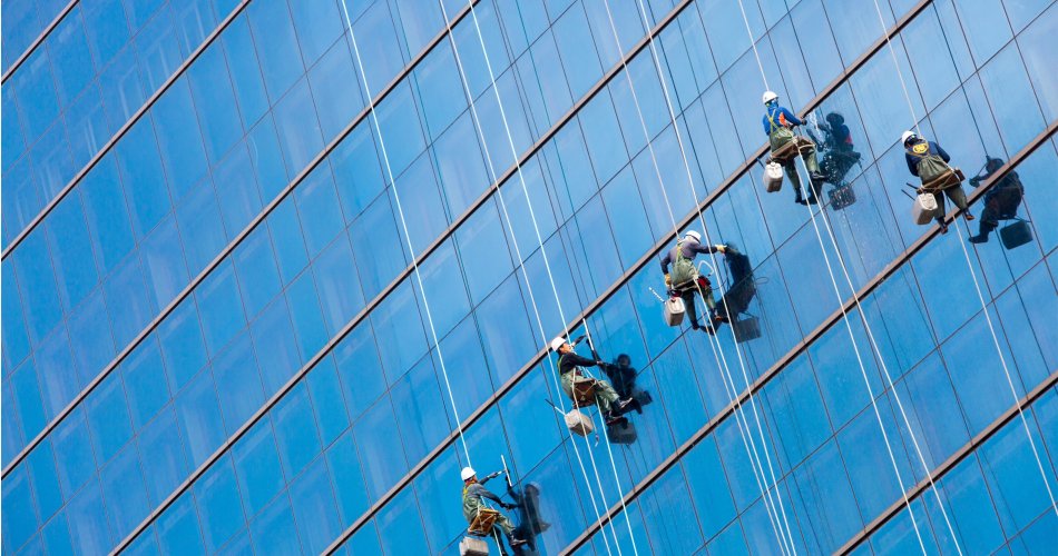 Maintenance employees cleaning the windows