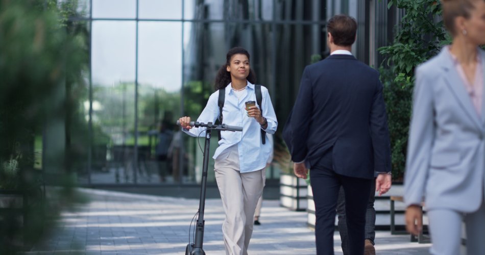 Business people walking and smiling in front of building