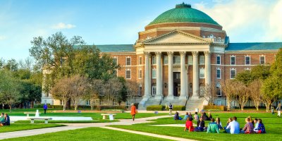 Students on the grass in front of the Southern Methodist University.
