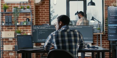 Man working behind desk on laptop