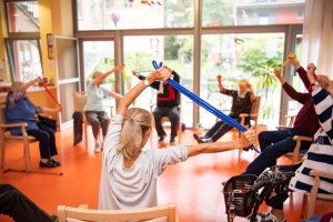 Group of elderly people stretching their arms