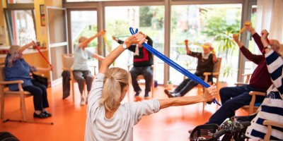 Group of elderly people stretching their arms