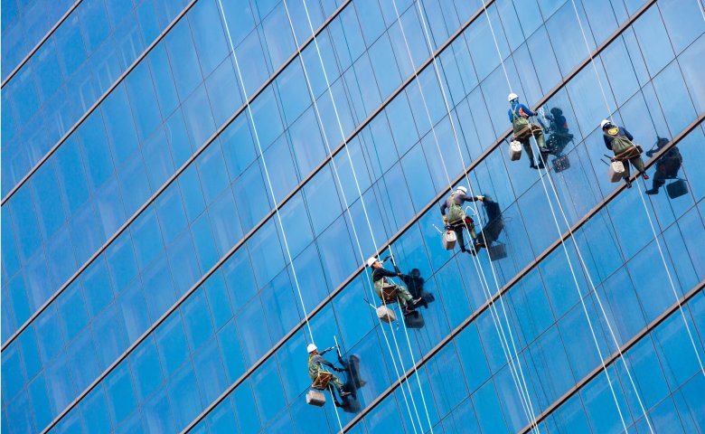 Maintenance employees cleaning the windows