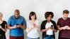 Group of people looking on their mobile phone.