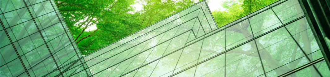 Glass building with trees on the background