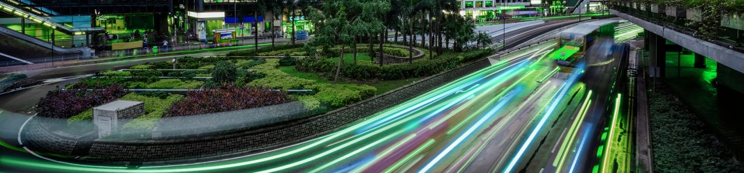 Impression of speed lights on a road in the middle of several skyscrapers