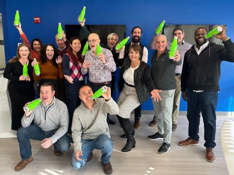 Group of Planon employees with green Planon bottles