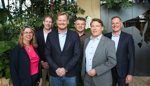The board members of Planon standing in a greenhouse of Planon's HQ.