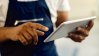 Close up mechanic working on tablet