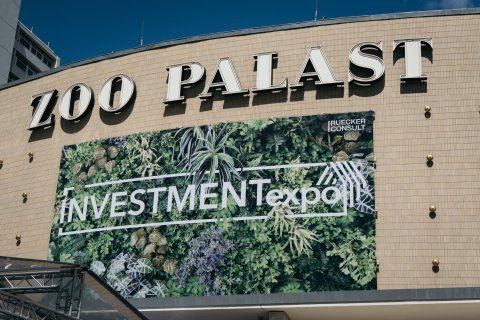 Exterior view of Zoo Palast venue with INVESTMENTexpo event branding banner.
