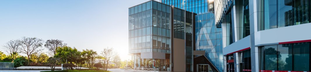 Office skyscrapers in city skyline, representing modern real estate and corporate properties.