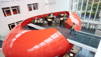 University Mezzanine with students having meetings and discussing group work at the campus.