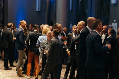 Close-up of event attendees engaging in conversations and networking.