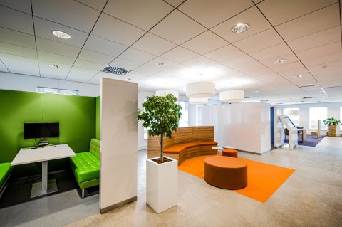 Office hallway with coloured meeting spaces.