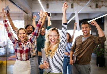 Business people cheering in their work space