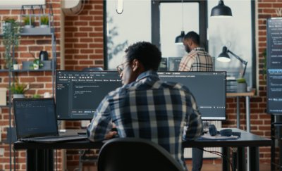 Man working behind desk on laptop