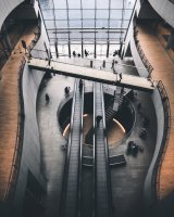 Bridge and escalators in a modern workspace.