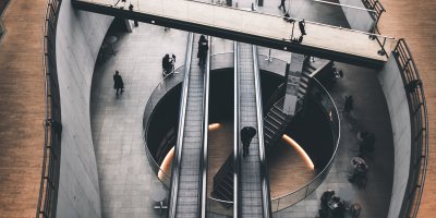 Bridge and escalators in a modern workspace.