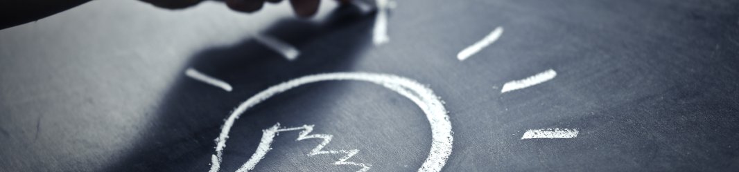 Man drawing a light with chalk on a board