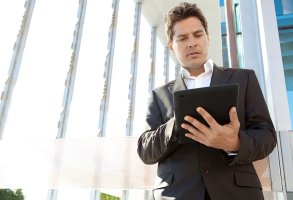 Businessman looking at a tablet in his hands.