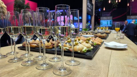 Visitors meeting and networking at the Planon Real Estate exhibition stand during the media breakfast.
