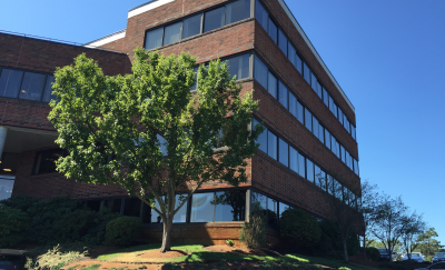 Planon Boston Office low rise with red brick and blue sky