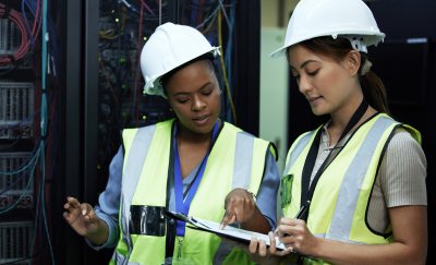 Two female maintenance engineers checking their work orders.