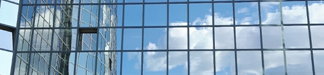 Planon Paris highrise glass office entrance with sky reflection in glass